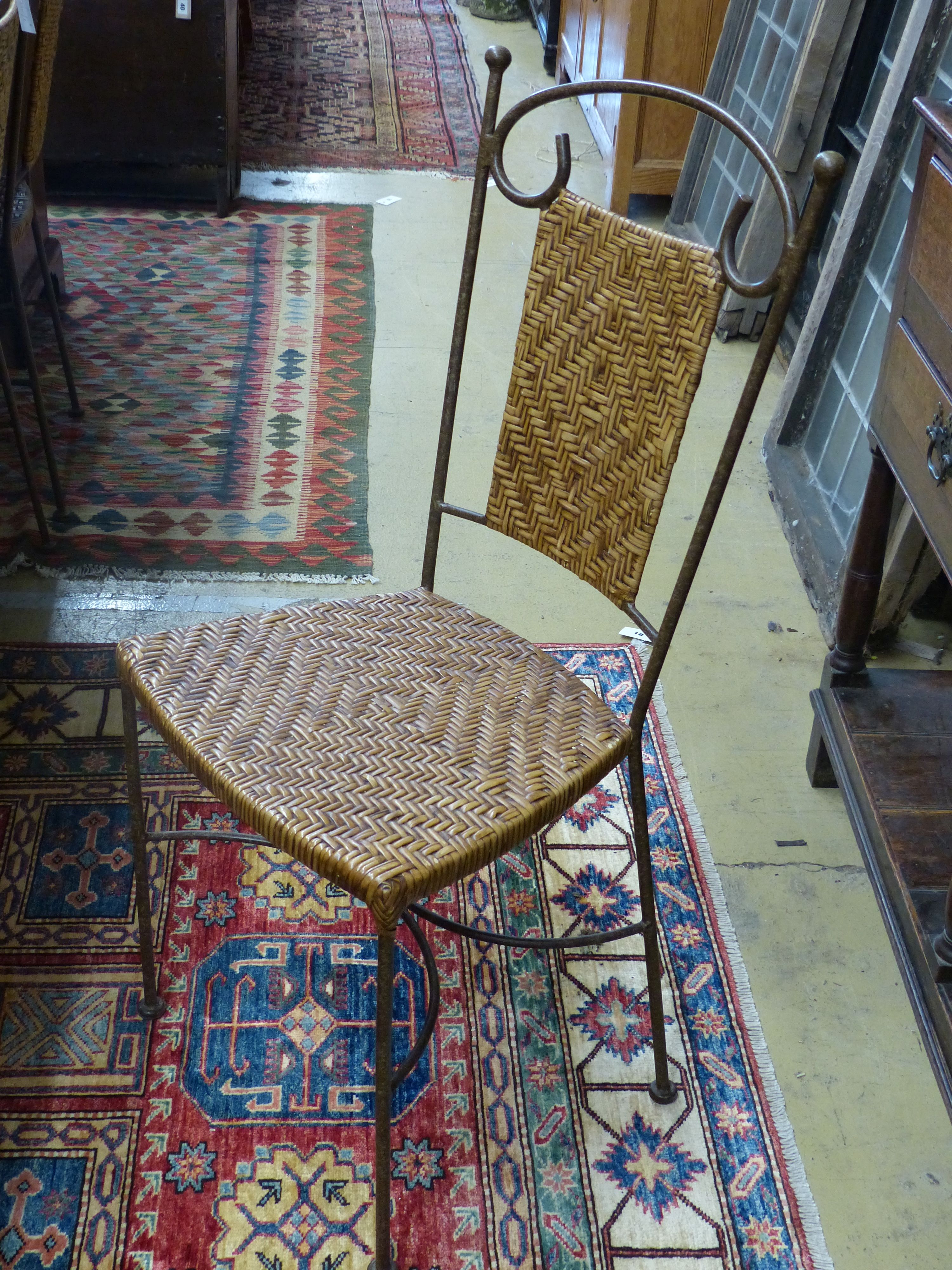 A set of contemporary wrought iron and rattan dining chairs